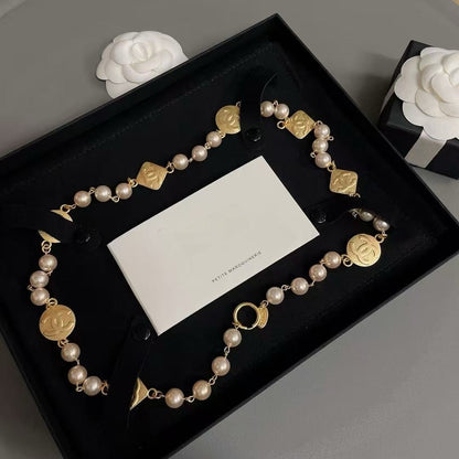 DreamStudio CHANEL necklace with cream faux pearls, gold-tone medallions, and black velvet ribbon in a gift box.