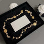 DreamStudio CHANEL necklace with cream faux pearls, gold-tone medallions, and black velvet ribbon in a gift box.