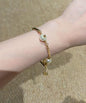 DreamStudio CHANEL gold-tone link bracelet featuring lustrous faux pearls and iconic logo-embossed metal accents