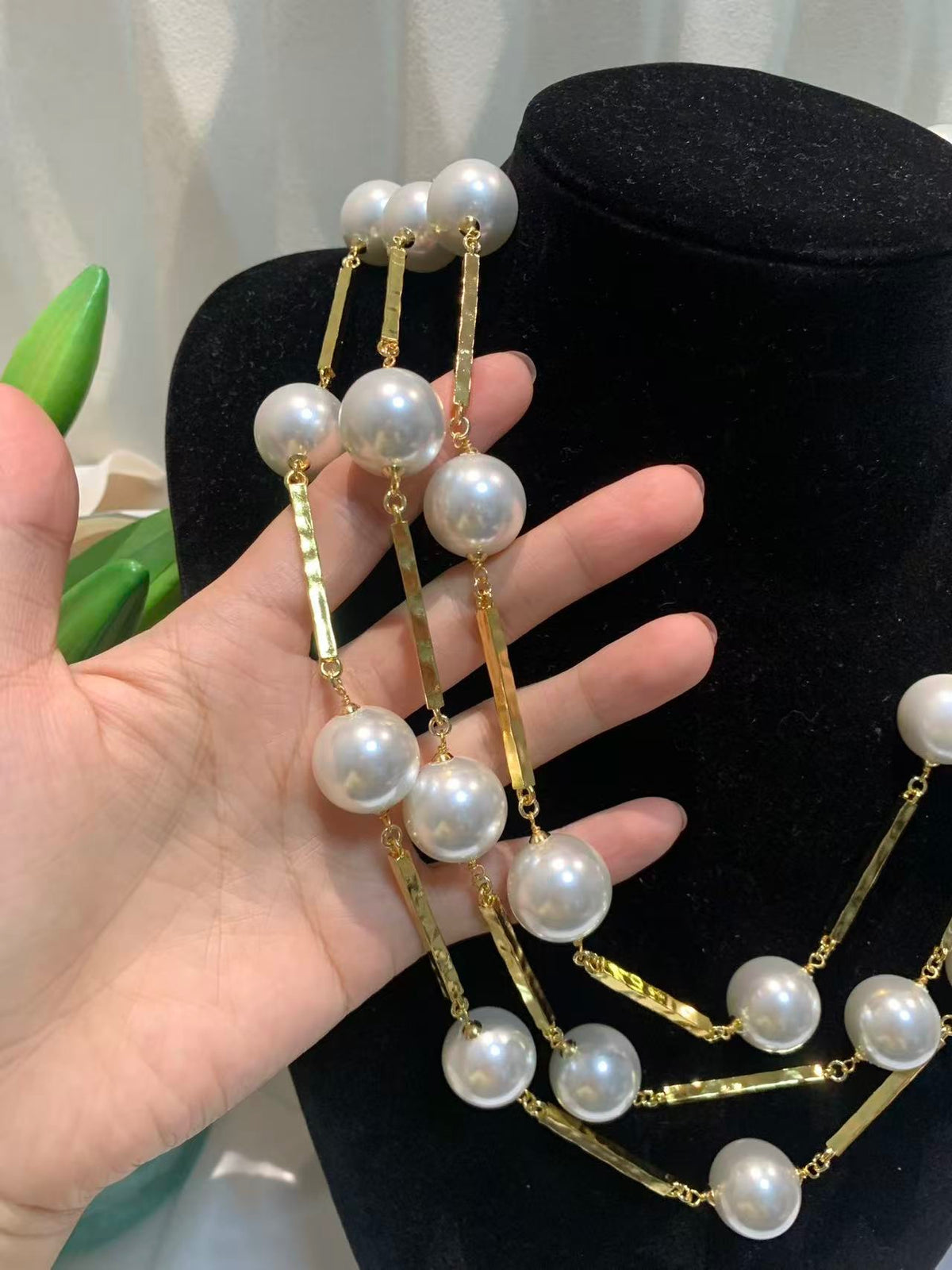 DreamStudio multi-strand statement necklace featuring lustrous white faux pearls and sleek gold-tone metallic bars.