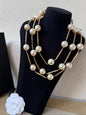 DreamStudio multi-strand statement necklace featuring lustrous faux pearls and gold-toned metallic bars on a display